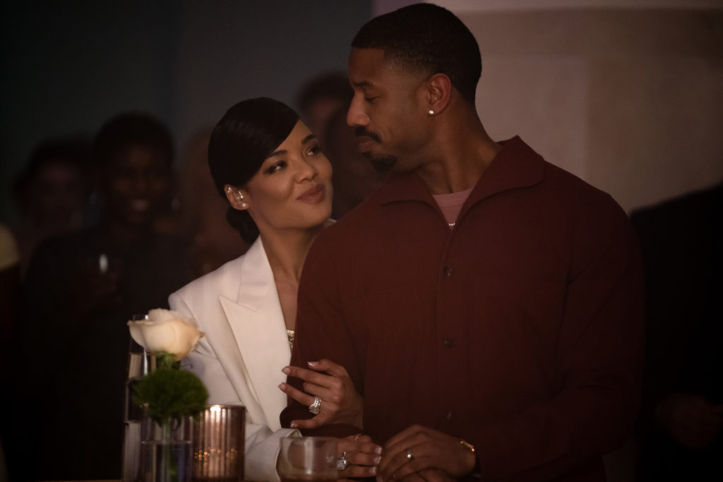 Tessa Thompson and Michael B. Jordan cozy up at a party in CREED III (2023)