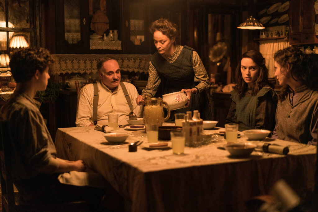 (L-R): Kim Bodnia as Henry Ederle, Jeanette Hain as Gertrud Ederle, Daisy Ridley as Trudy Ederle in Disney's live-action YOUNG WOMAN AND THE SEA. Photo by Elena Nenkova. © 2024 Disney Enterprises, Inc. All Rights Reserved.