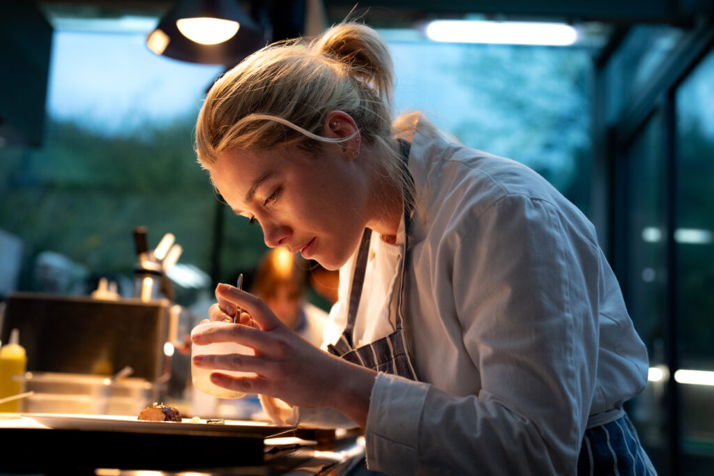 Florence Pugh works as a chef in WE LIVE IN TIME (2024)